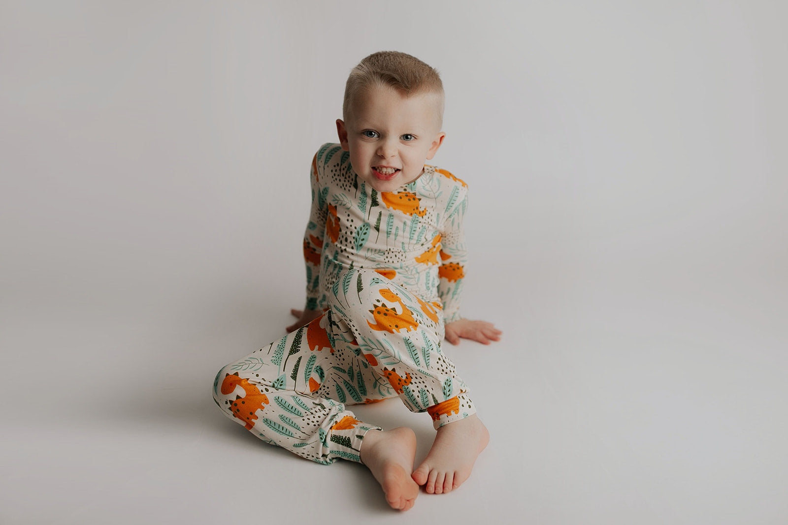 Toddler and big kid jammies in matching prints and solids, designed for comfy bedtime or lounging all day. Dinosaur themed Kids Pajamas.