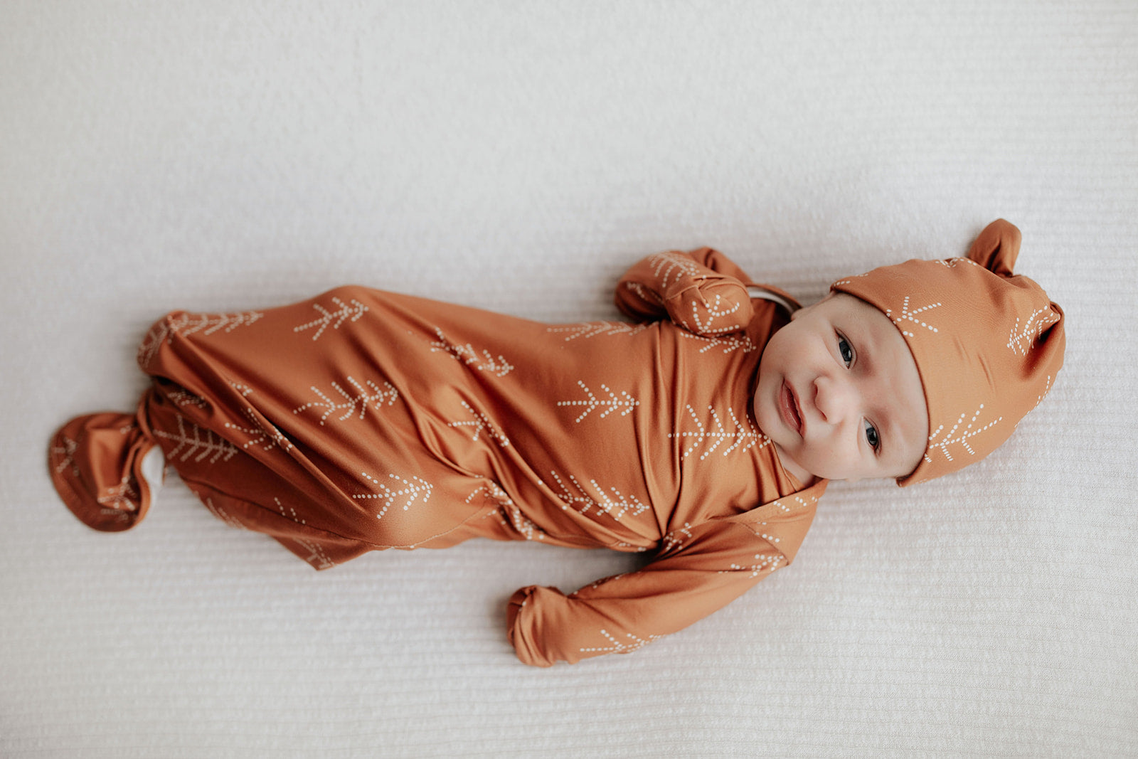 Super soft Christmas-themed baby gowns with stretchy fabric and easy-access tie bottom for quick diaper changes.