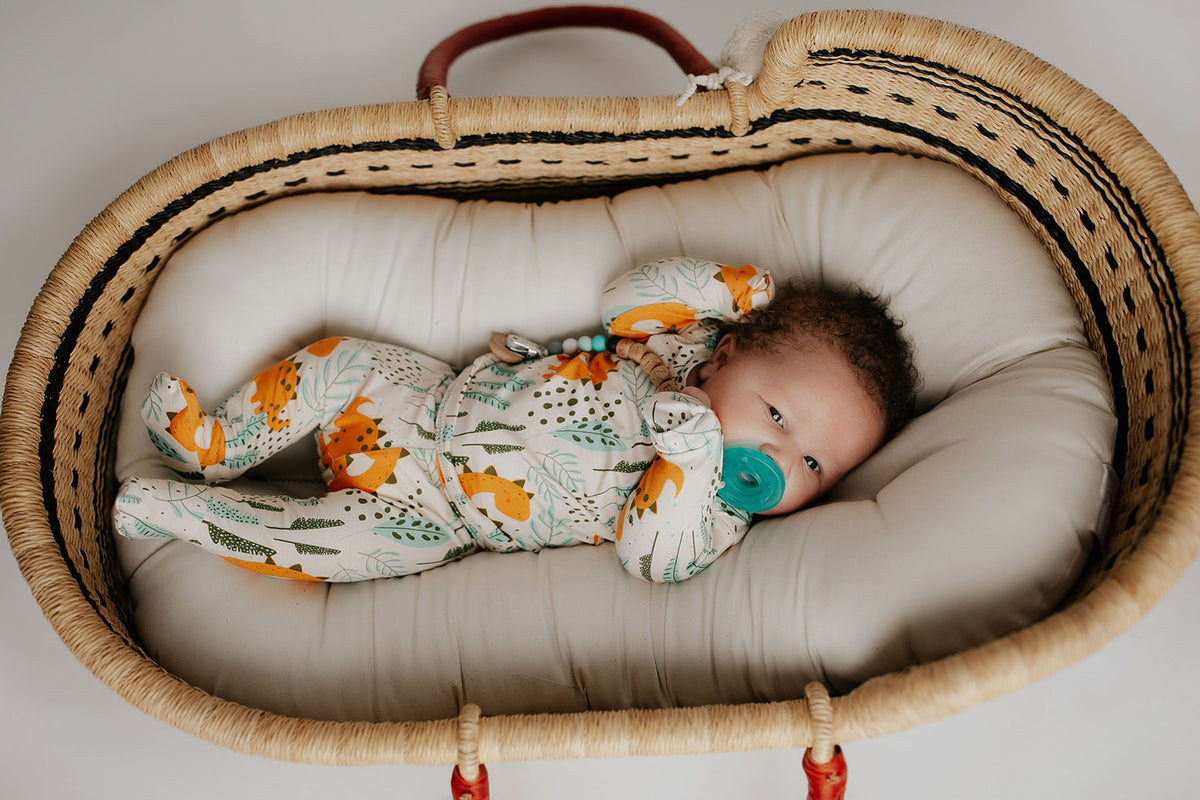 Toddler and big kid jammies in matching prints and solids, designed for comfy bedtime or lounging all day. Moses basket by Plum and Sparrow. Snuggle me newborn 