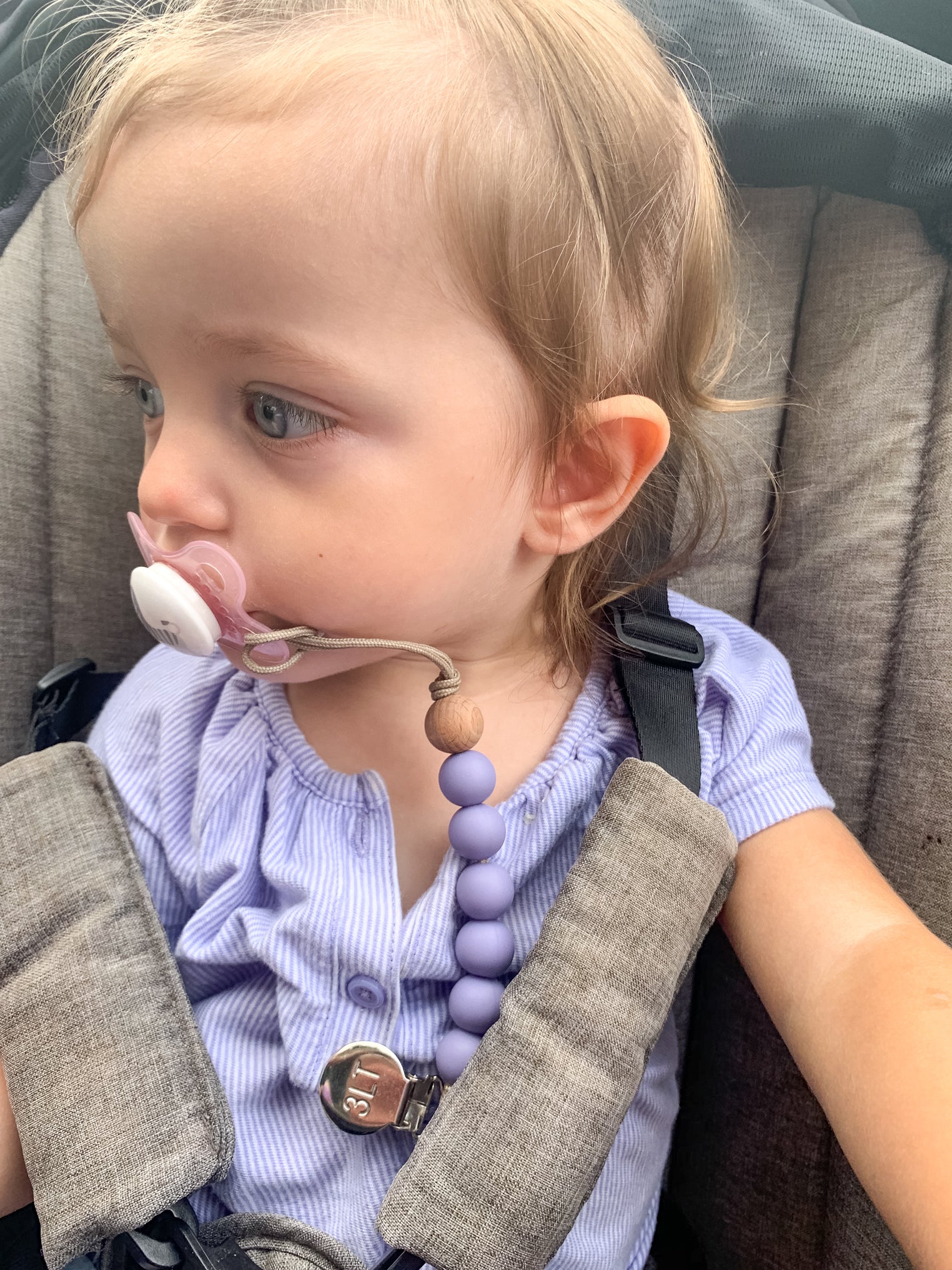 Little girl with a Three Little Tots Silicone Beaded Pacifier Clip in lavender