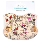 Little girl eating with a Three Little Tots floral silicone bib