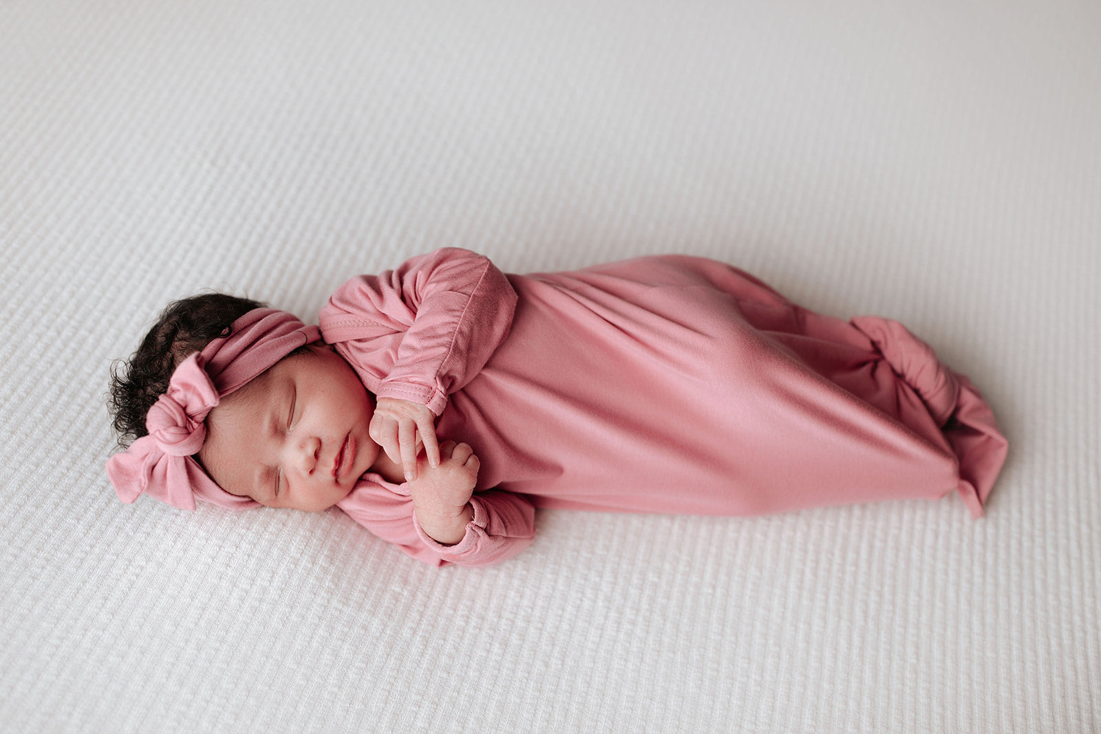 Luxuriously soft modal knotted baby gowns for newborn babies, offering comfort, easy diaper changes, and style. Three Little Tots Rose Pink Knotted baby gown. Knotted tie bottom mimics the womb to bring comfort to your newborn