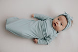 Capture precious moments with a newborn photoshoot featuring adorable knotted gowns for timeless photo ideas.