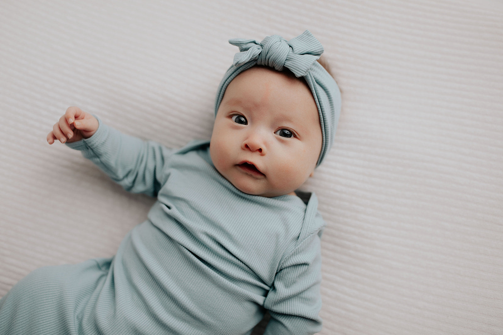 Capture precious moments with a newborn photoshoot featuring adorable knotted gowns for timeless photo ideas.