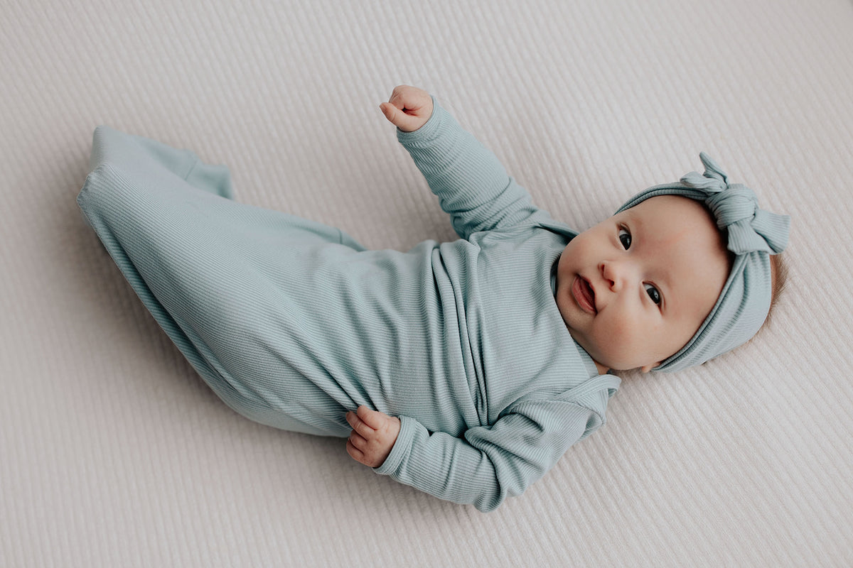 Capture precious moments with a newborn photoshoot featuring adorable knotted gowns for timeless photo ideas.