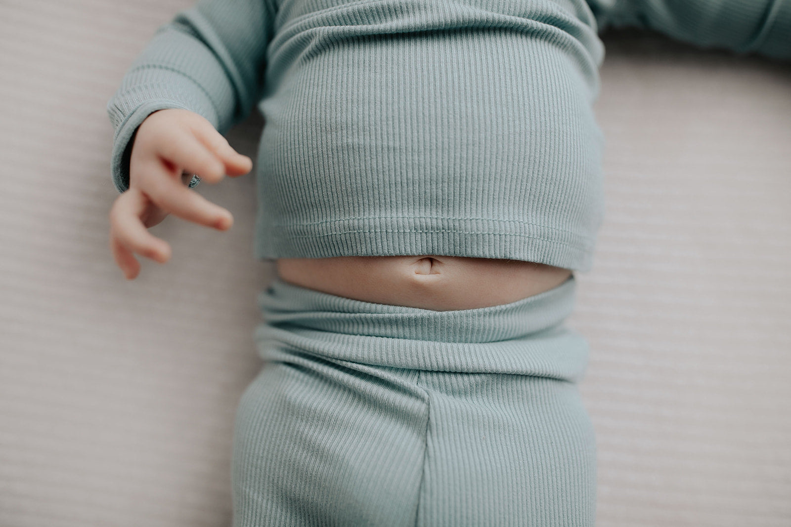 a newborn photoshoot with  ultra soft pajamas from Three Little Tots