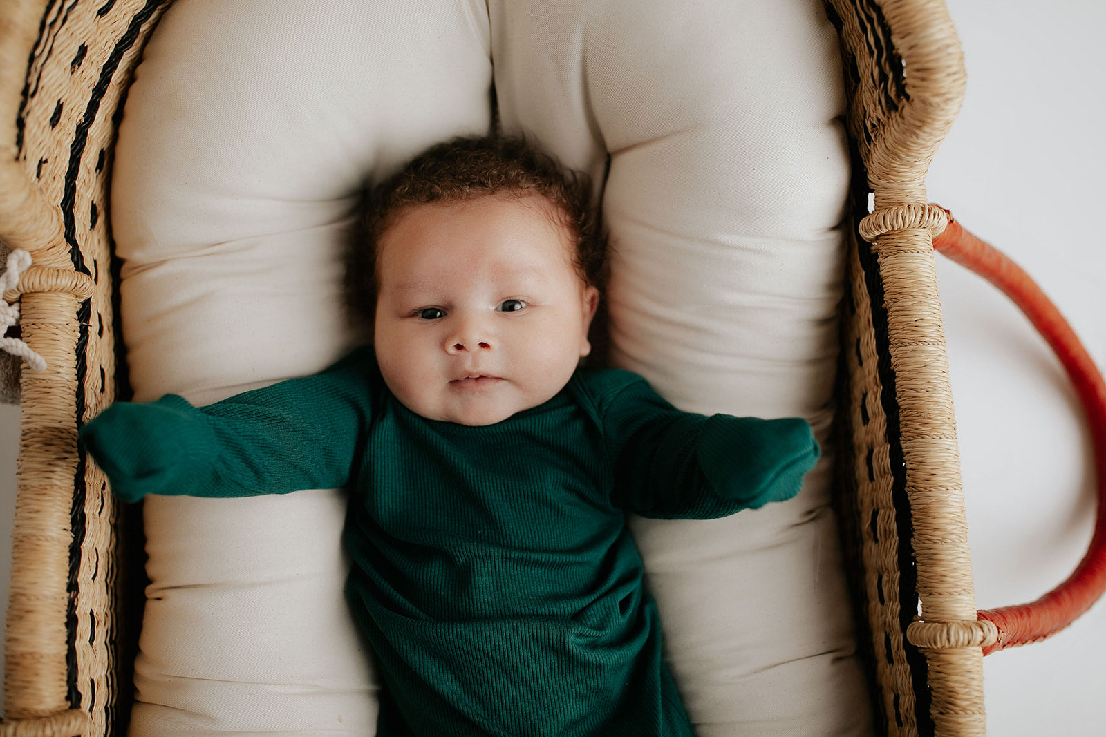 Ultra-soft baby gowns with tie bottoms for easy nighttime changes and pull-down tabs for effortless dressing. Perfect for a Christmas baby. Shown in a Snuggle Me in a Plum + Sparrow Moses Basket