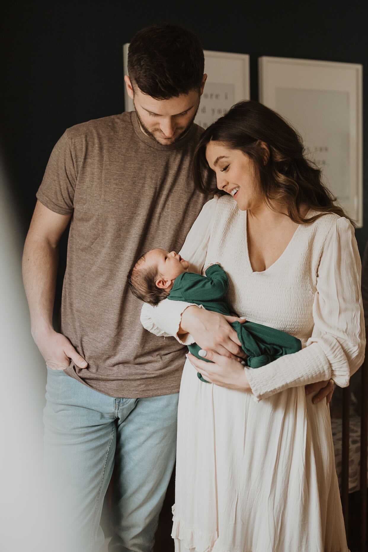 Newborn family photoshoot. Baby is wearing Three Little Tots Forest Green Knotted Gown
