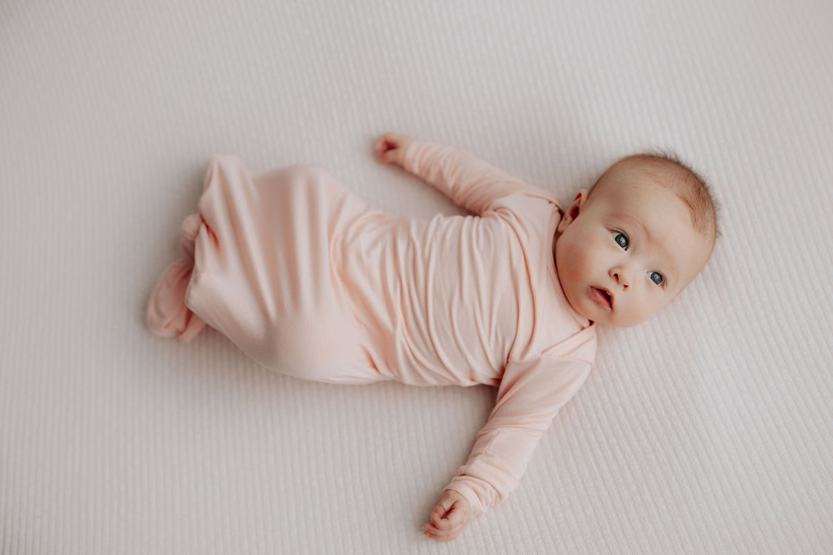 cute newborn photo of a baby in the Three Little Tots Knotted Baby Gown