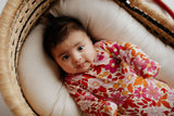Three Little Tots Wild Child Knotted Gown on a newborn baby girl in a Snuggle Me in a Plum and sparrow moses basket