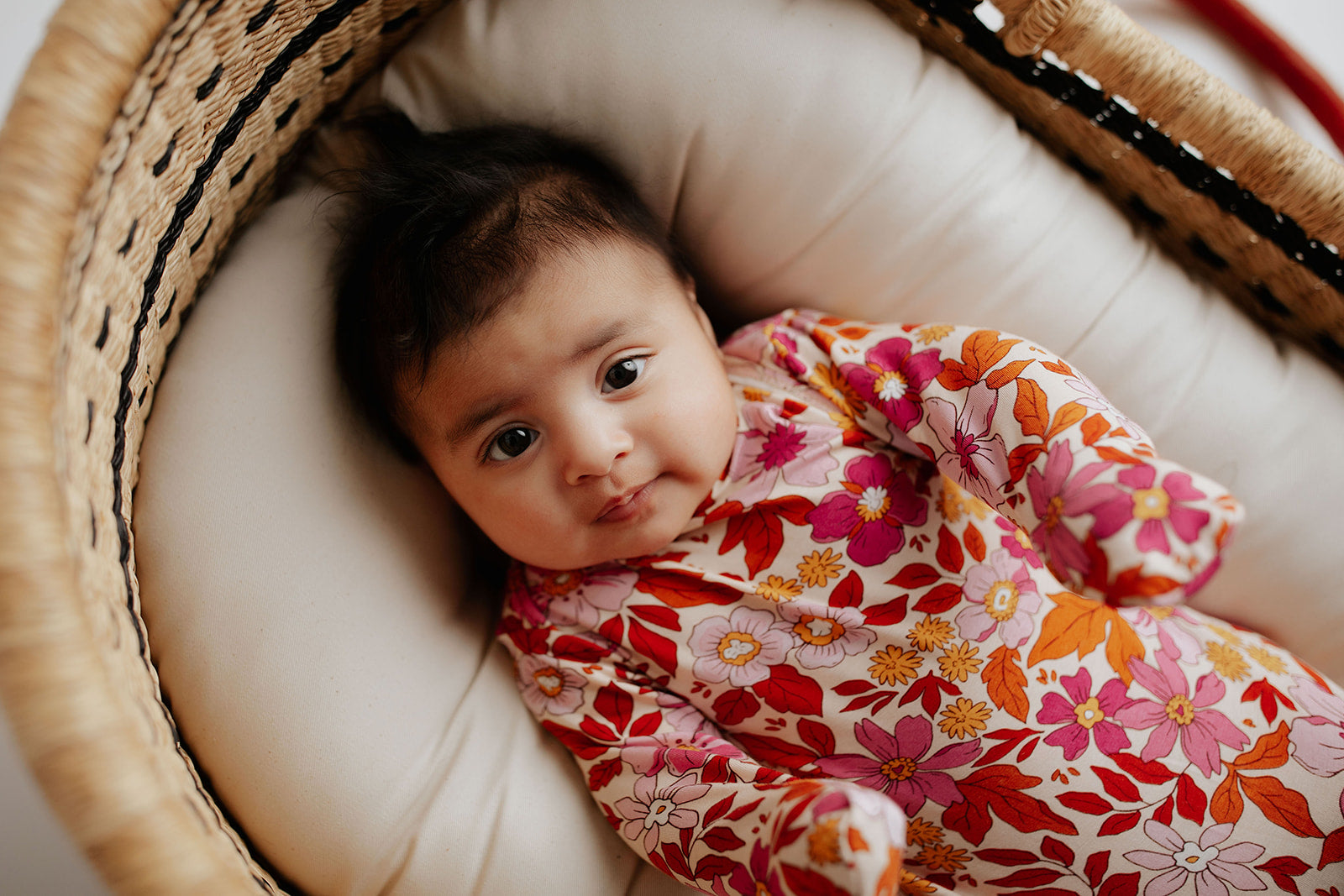 Three Little Tots Wild Child Knotted Gown on a newborn baby girl in a Snuggle Me in a Plum and sparrow moses basket