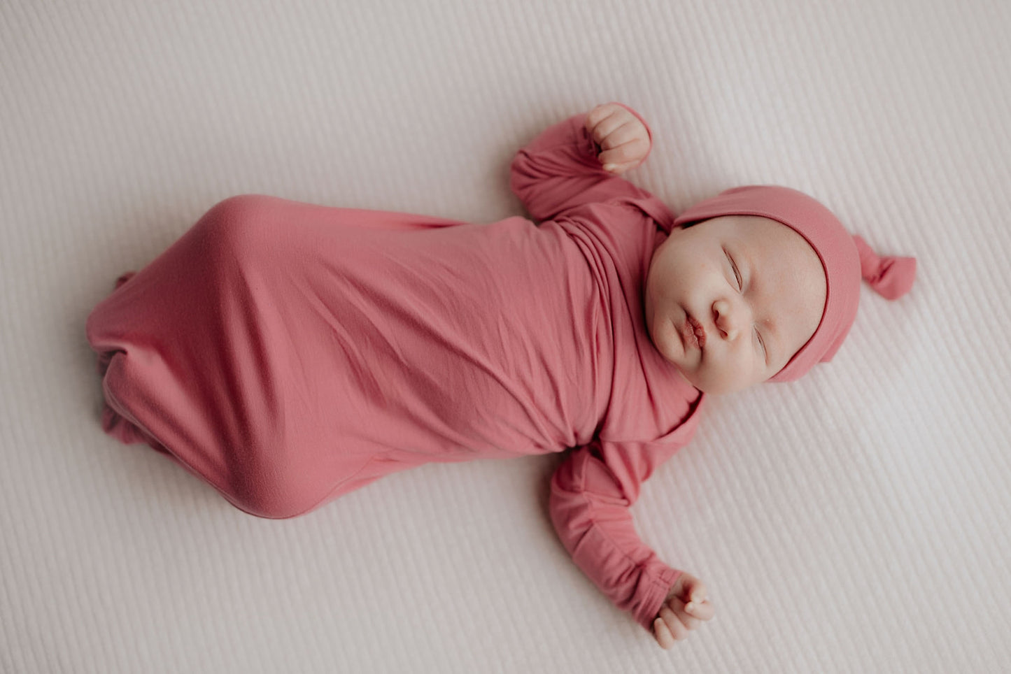 Luxuriously soft modal knotted baby gowns for newborn babies, offering comfort, easy diaper changes, and style. Three Little Tots Rose Pink Knotted baby gown. Knotted tie bottom mimics the womb to bring comfort to your newborn