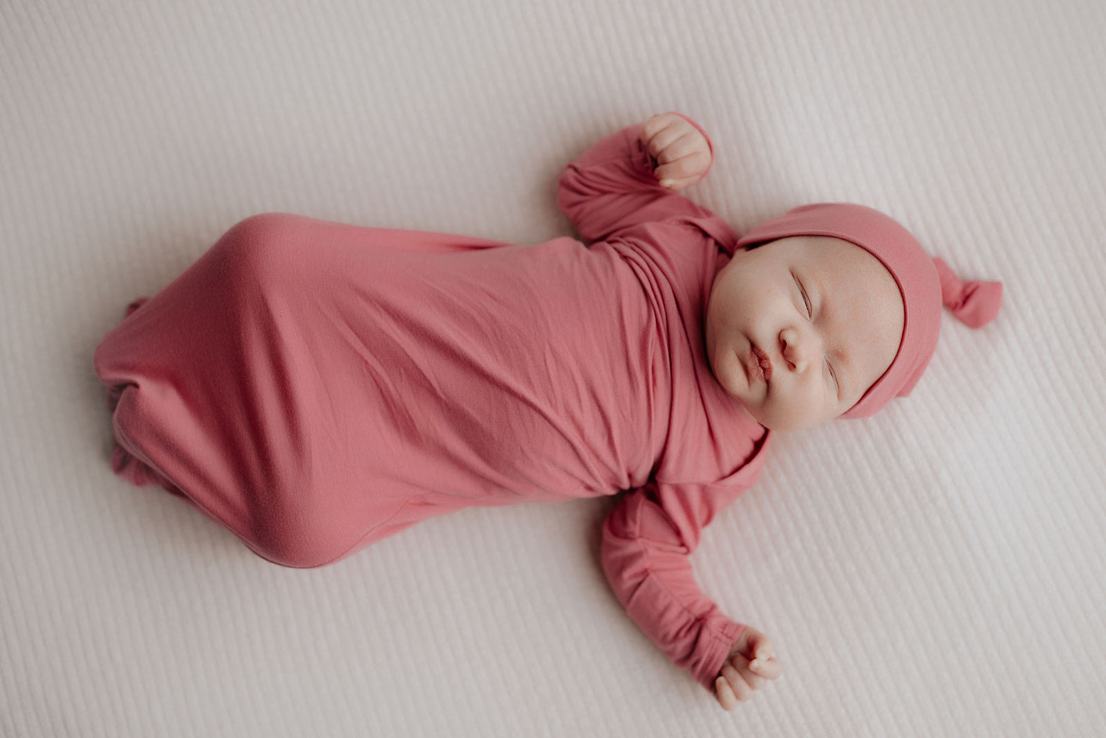 Luxuriously soft modal knotted baby gowns for newborn babies, offering comfort, easy diaper changes, and style. Three Little Tots Rose Pink Knotted baby gown. Knotted tie bottom mimics the womb to bring comfort to your newborn