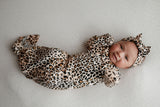 Three Little Tots Knotted baby gown features fold over mittens and a tie bottom that mimics the womb to bring comfort to newborns.