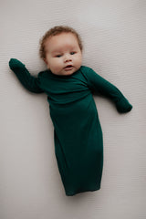 Ultra-soft newborn baby gowns with tie bottoms for easy nighttime changes and pull-down tabs for effortless dressing.