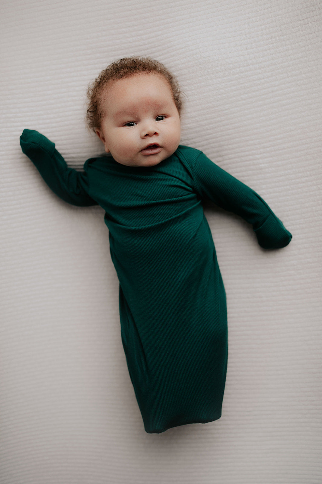 Ultra-soft newborn baby gowns with tie bottoms for easy nighttime changes and pull-down tabs for effortless dressing.