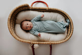 Newborn photoshoot with a Plum + Sparrow Moses basket and a Three Little Tots newborn knotted baby gown
