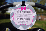 A sign for a newborn's car seat for premature babies that is a friendly reminder to look and not touch the baby