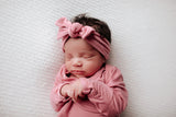 Luxuriously soft modal knotted baby gowns for newborn babies, offering comfort, easy diaper changes, and style. Three Little Tots Rose Pink Knotted baby gown. Knotted tie bottom mimics the womb to bring comfort to your newborn