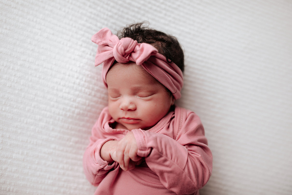 Luxuriously soft modal knotted baby gowns for newborn babies, offering comfort, easy diaper changes, and style. Three Little Tots Rose Pink Knotted baby gown. Knotted tie bottom mimics the womb to bring comfort to your newborn