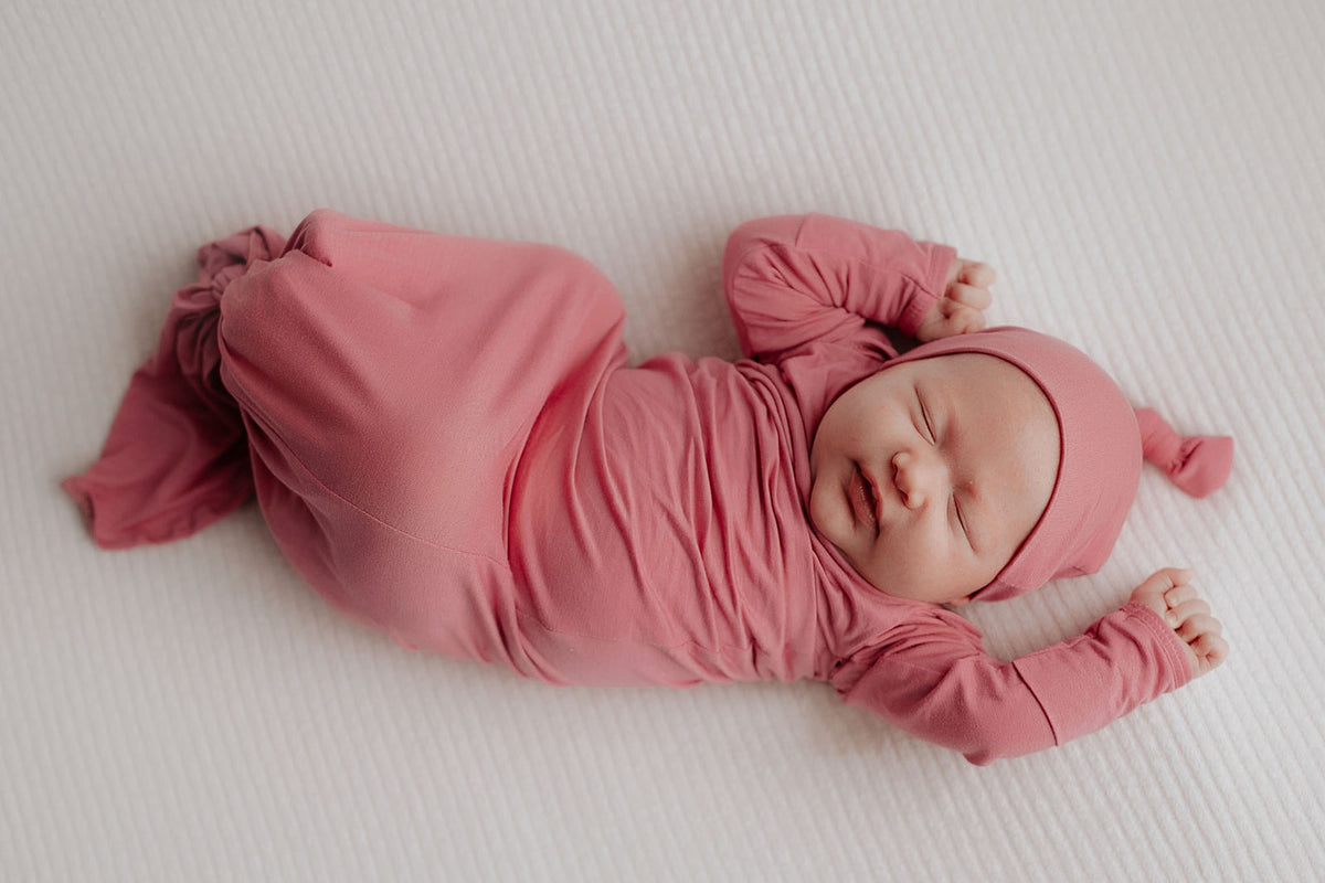 Luxuriously soft modal knotted baby gowns for newborn babies, offering comfort, easy diaper changes, and style. Three Little Tots Rose Pink Knotted baby gown. Knotted tie bottom mimics the womb to bring comfort to your newborn